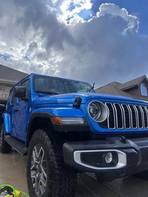 Detailed blue Jeep parked outside in Aledo, Texas