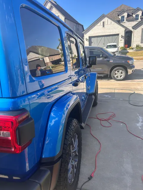 Reflective blue Jeep door panel after exterior detailing